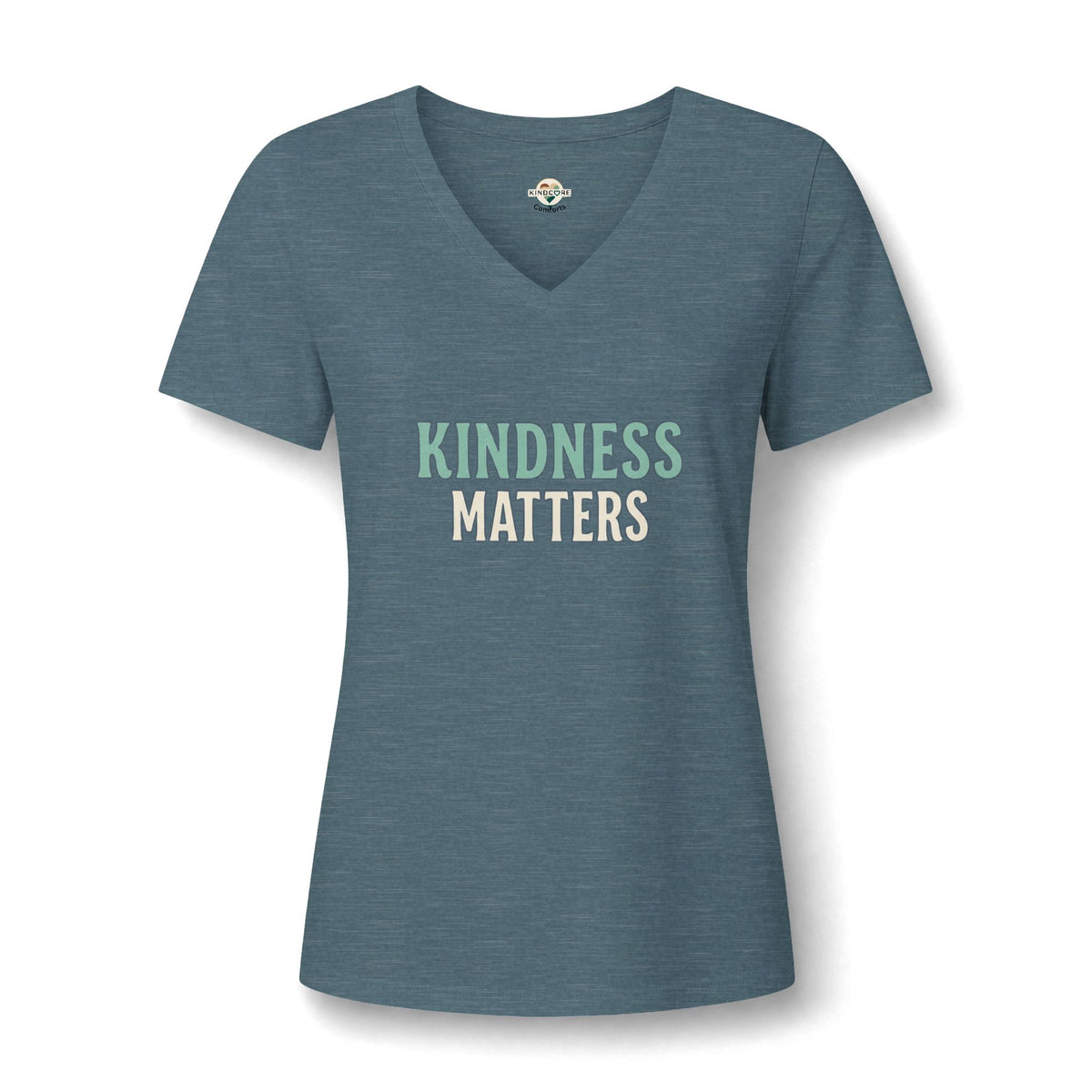 A women's slate blue V-neck t-shirt with the words 'KINDNESS MATTERS' printed on the chest in light green and cream.