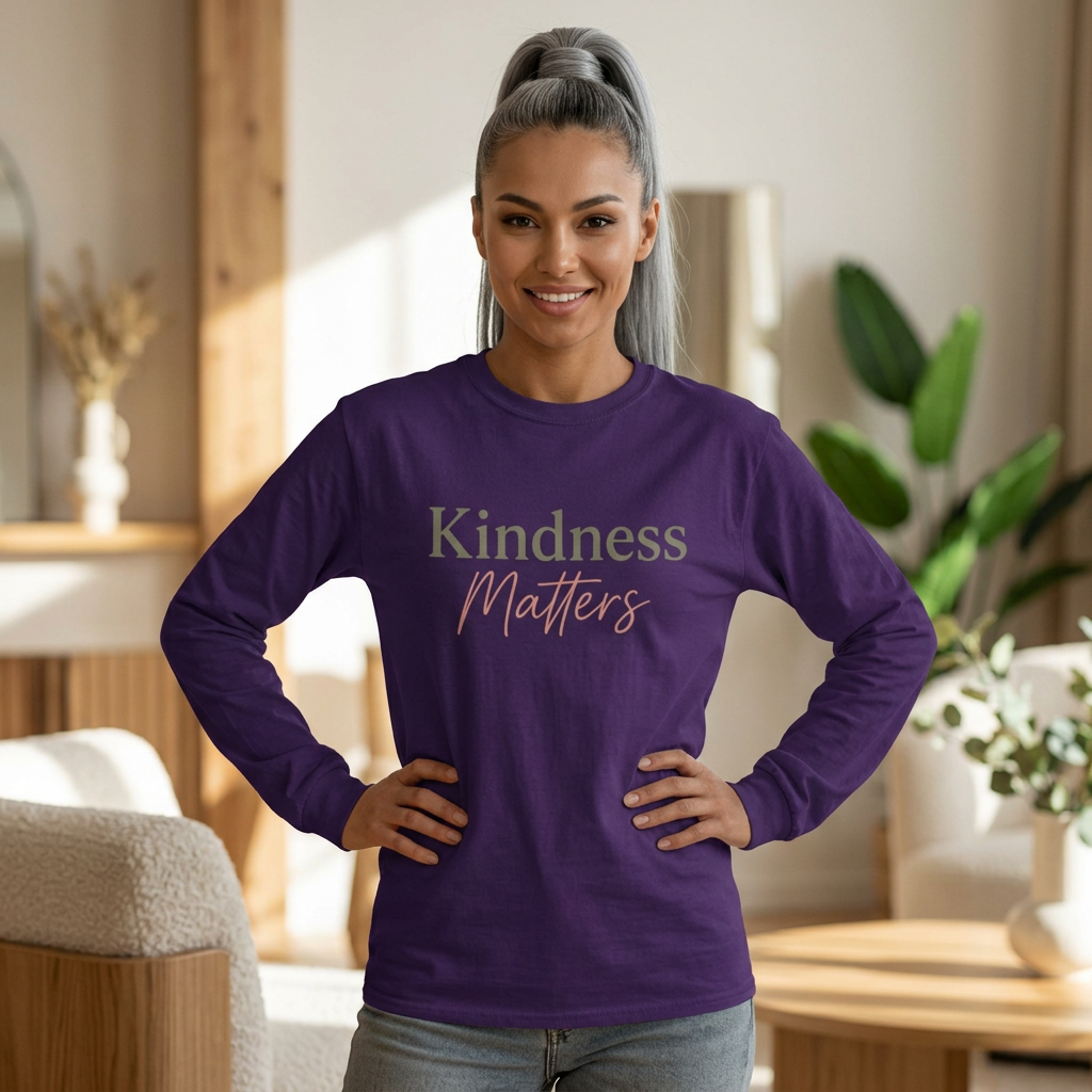 Woman wearing a purple long-sleeve tee with “Kindness Matters” in green and pink lettering.