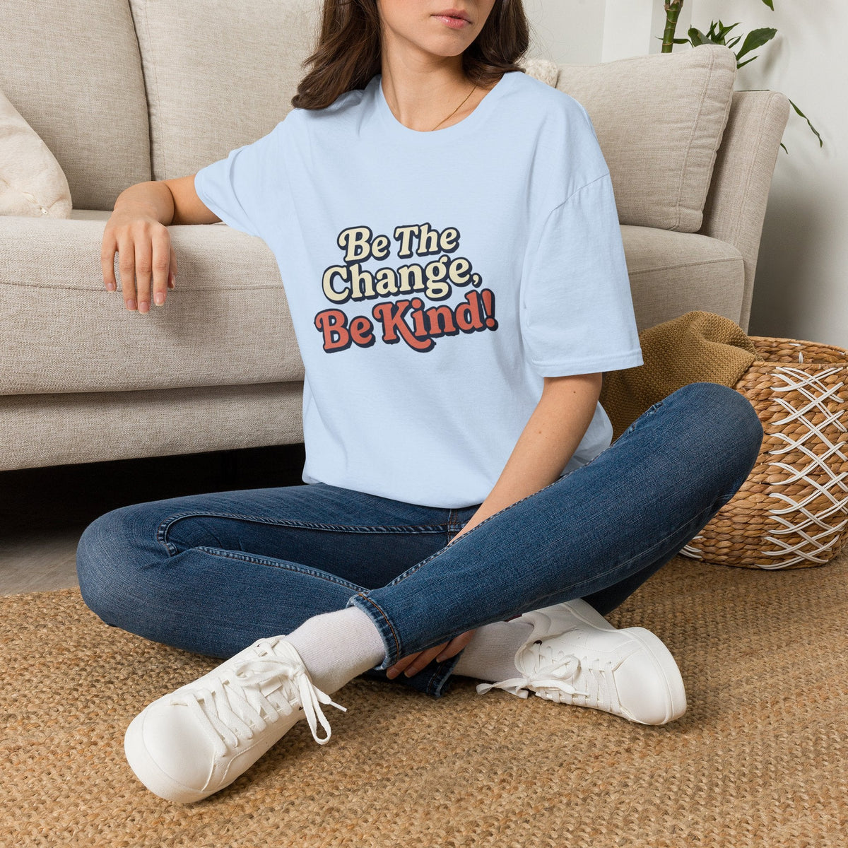 Be the Change Be Kind T-Shirt - Kindcore ComfortsPerson sitting on a couch wearing a light blue t-shirt with a graphic design and text.ST-ShirtPrintifyKindcore Comforts92748922639395179428
